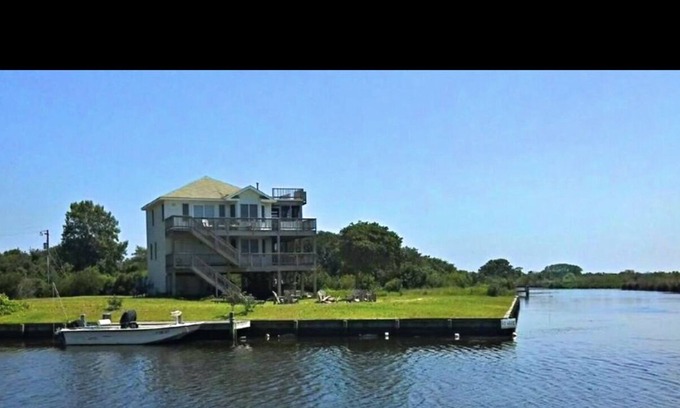 Carova Beach Cottage | Beautiful Canal front home in 4x4 area beach parking passes and linens included!