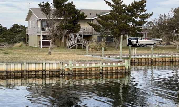 Frisco House | Canal Front Home with a Dock and Hot Tub minutes from the beach!