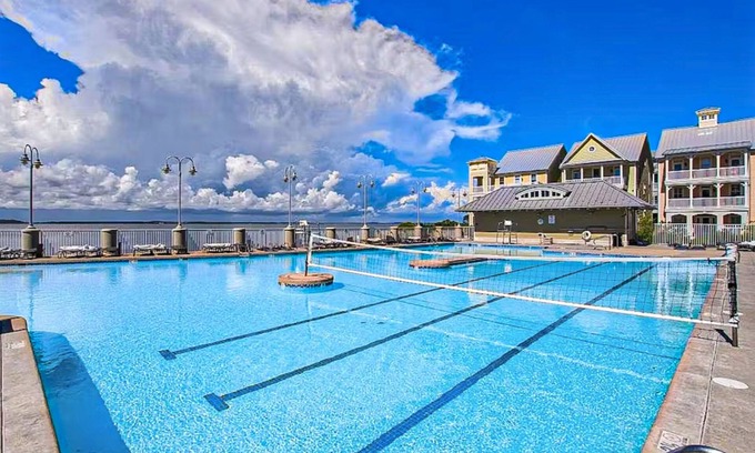 Sunset Island House | Coastal retreat with beach and shared pool - balconies, AC, & W/D