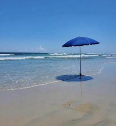 New Smyrna Beach Apartment | Fall Beach days available! Steps to the Sea!
