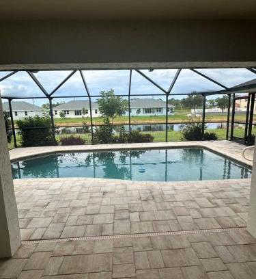 Pebble Beach House | Heated pool with canal views