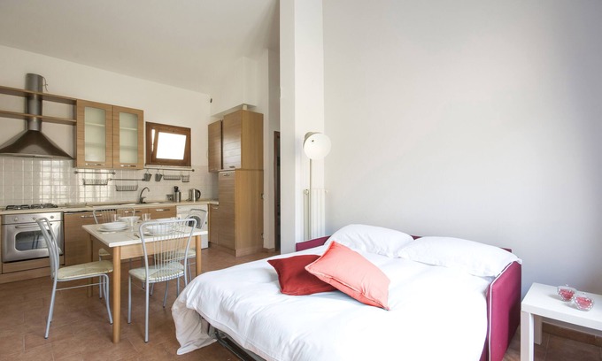 Pisa Apartment | JOIVY Red Terraced Apartment