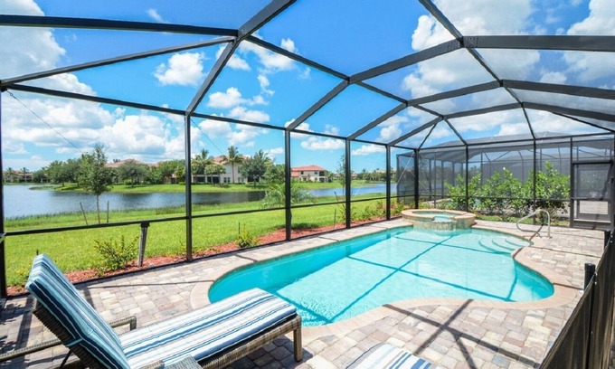 Naples House | Luxurious lakeview pool home in 5 Star Fiddler's Creek. Outdoor Dining & Kitchen