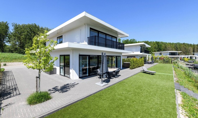 Zeewolde House | Luxury 16-person villa by the water. Two spacious villas with hot tubs, Finnish saunas, private jetties, large terraces, and modern kitchens.
