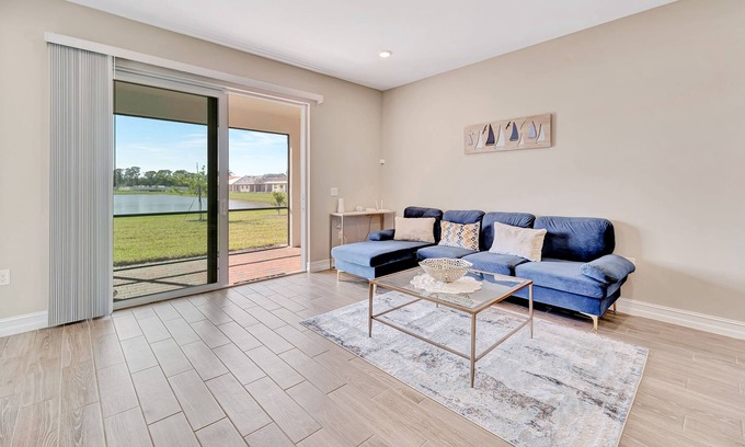 Venice House | Newly built, single-story home on a lagoon with a porch, pool and bocce courts
