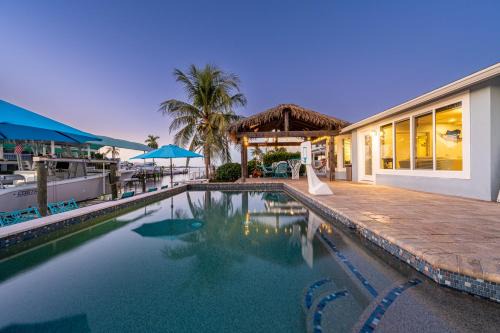 Whitney Beach House | Royal Palm Paradise! Waterfront, Private Pool & Hot Tub, Boat Dock!