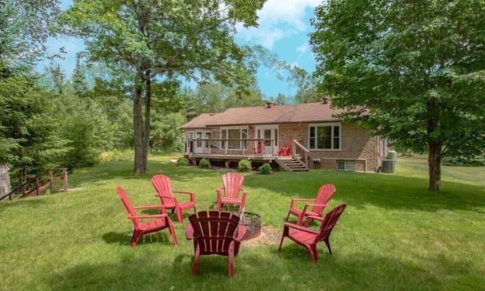 Kearney Cottage | Sand Lake Getaway - Modern Riverfront Cottage w/Swimming & Hot Tub