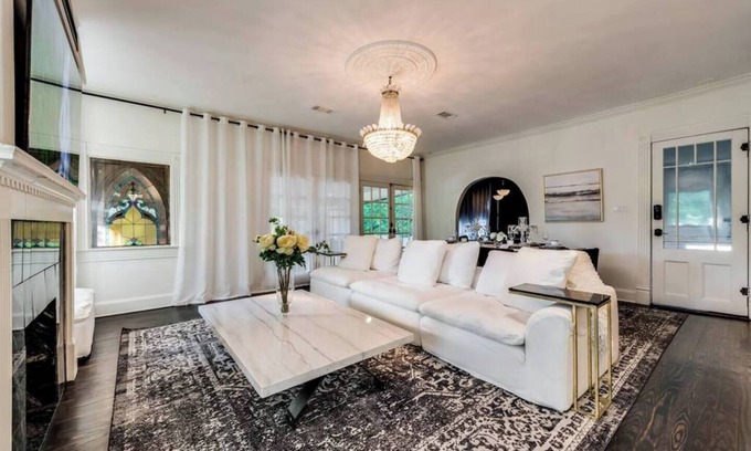 Old East Dallas House | Step into Dallas elegance, where historic architecture meets modern luxury living just minutes from Downtown. Featuring soaring ceilings, crystal chandeliers, and a grand stone fireplace, this home blends timeless design with contemporary comfort.