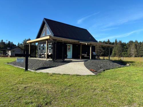 Sandspit House | Sunrise Cabin- The Loft - secluded Beach front guest house