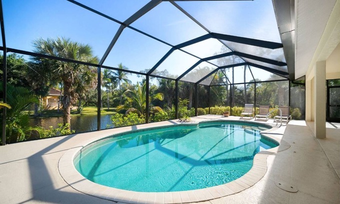 Palm River Estates House | Vibrant home close to best beach parks and shops backyard pool with a lake