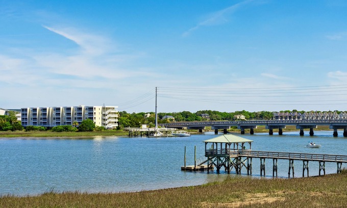 Waters Edge House | Water's Edge 114 - River Daze - Premier Riverfront Townhome - Pool & Fishing Pier!