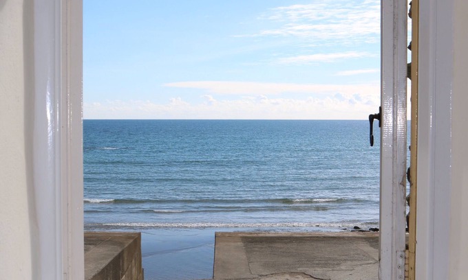 Portholland Cottage | Wonderful reverse level conversion located on the sea front in picturesque rural hamlet on the South