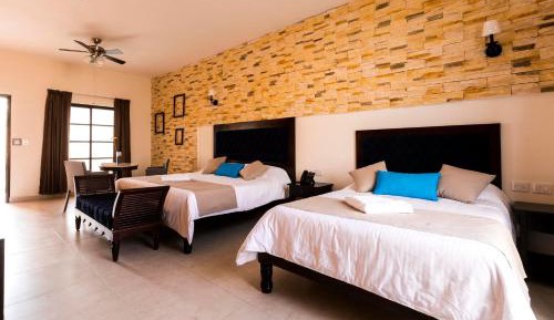 Junior Suite 1 king size bed and 1 double bed, living room, pool and garden view