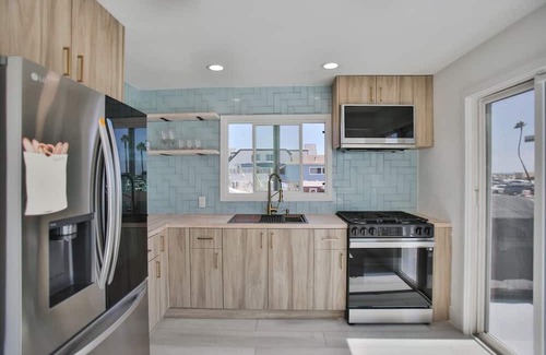 Huntington Harbour Cottage | STEPS TO PRIVATE BEACH FRONT PANORAMIC OCEAN VIEWS! Home - parking lot - sand.