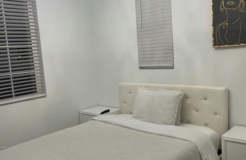 Upland House | Beautiful bedroom 02 with a private bathroom featuring a tub and shower.