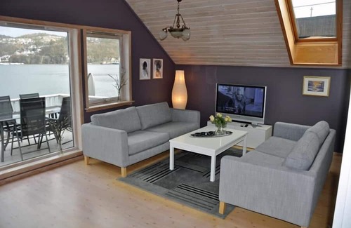 Flekkefjord Apartment | Holiday apartment "Fagerstrand 1", in Flekkefjord, southern Norway, in a beautiful location directly on the water, 4-6 persons, open living-dining area, 2 bedrooms, 1 loft with double mattress, 1 bathroom, Internet, own small veranda with access t...