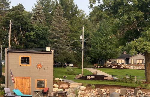Rapid City House | 50 feet of Torch Lake frontage! Boathouse, beautiful patios sweet little beach.